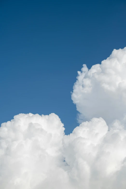 a plane flying through a large cluster of clouds