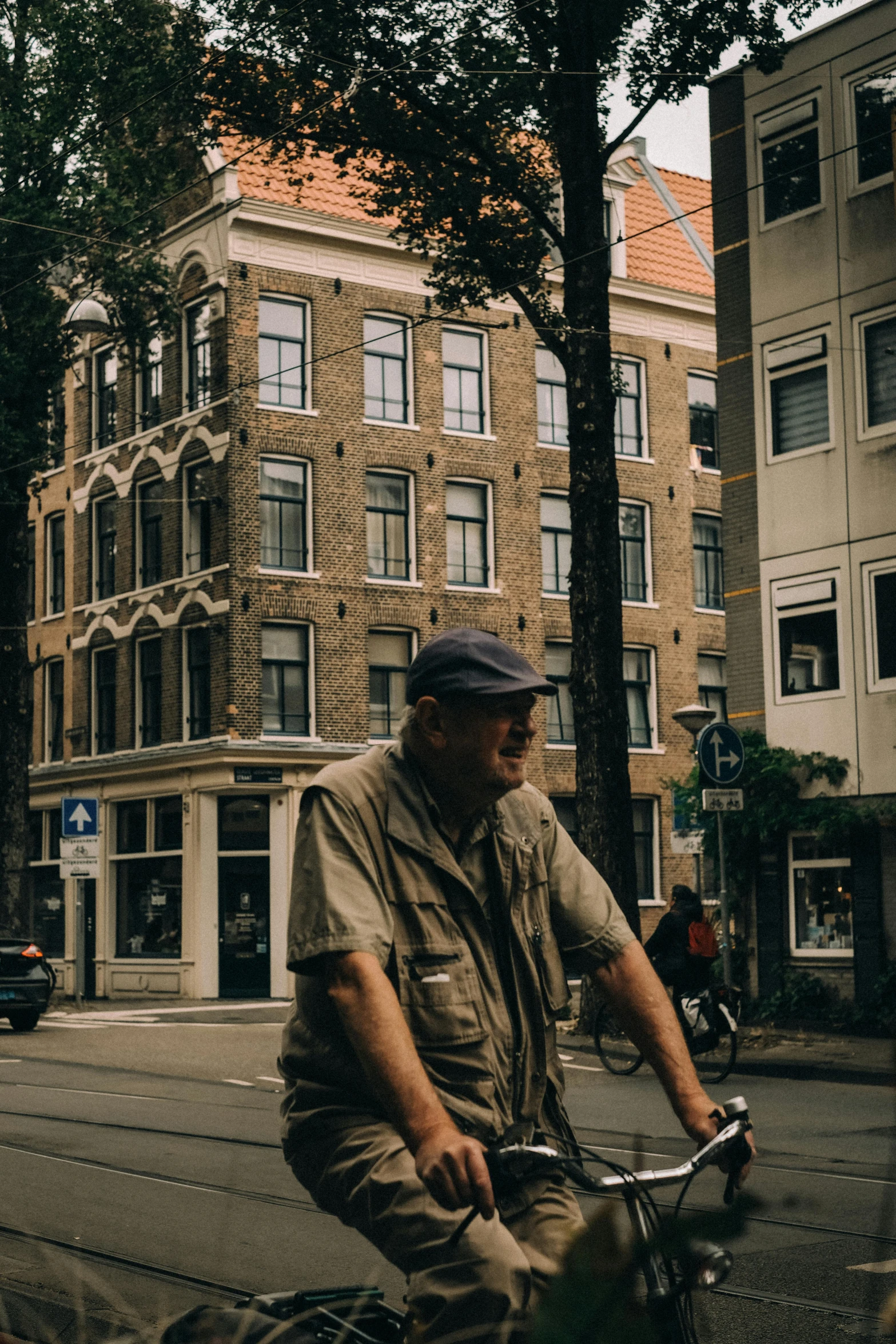 a man is riding a bicycle down a city street