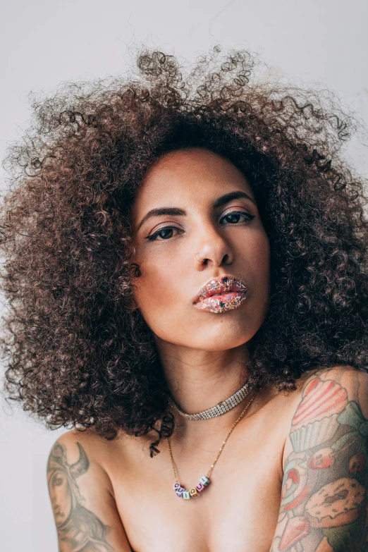 a woman with tattoos and a piercing around her neck