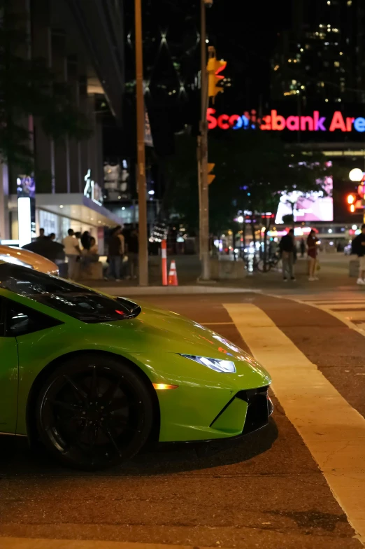 a bright green sports car is on the side of the road