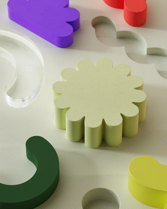 various colors of paper and shapes on a surface