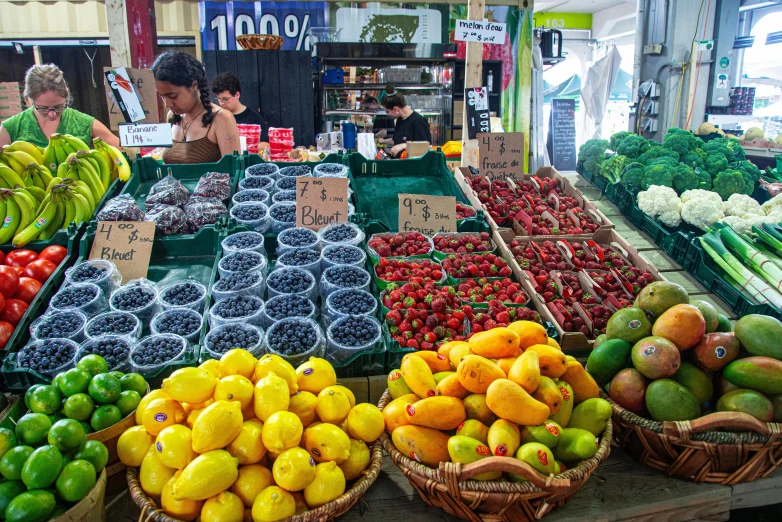 the large produce market is full of fresh fruits and vegetables