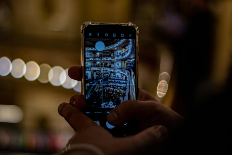 woman using cellphone in dark with blurry image