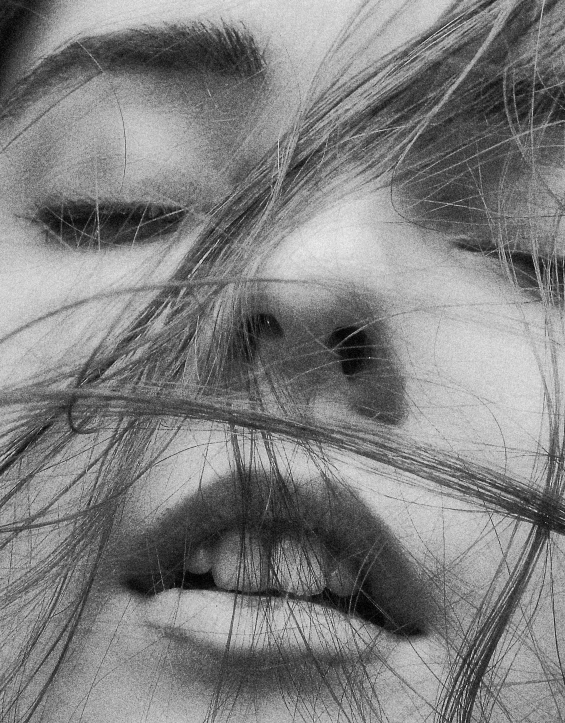 a close up s of a woman's nose with long hair