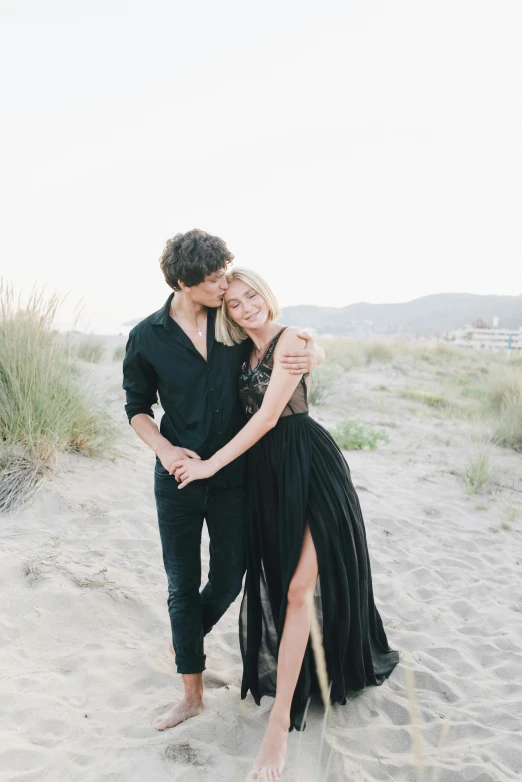 a couple is having a passionate moment on the beach