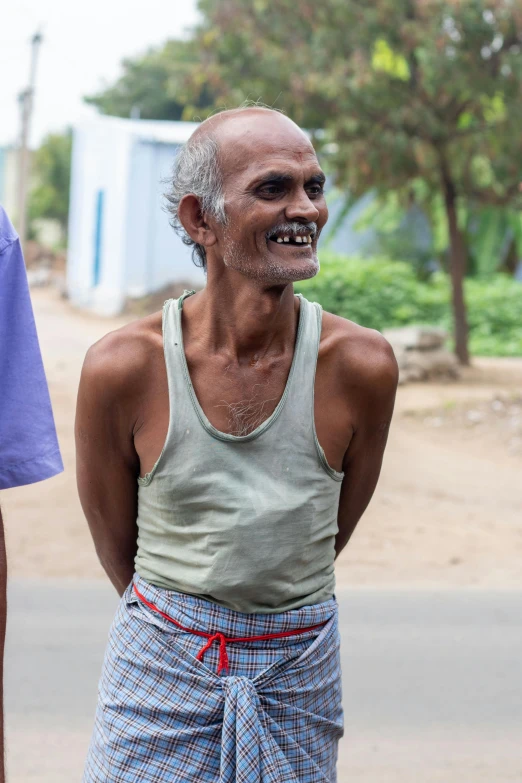 an old man with white hair wearing shorts