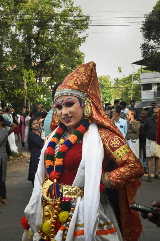 colorful woman dressed in costume walking on a street