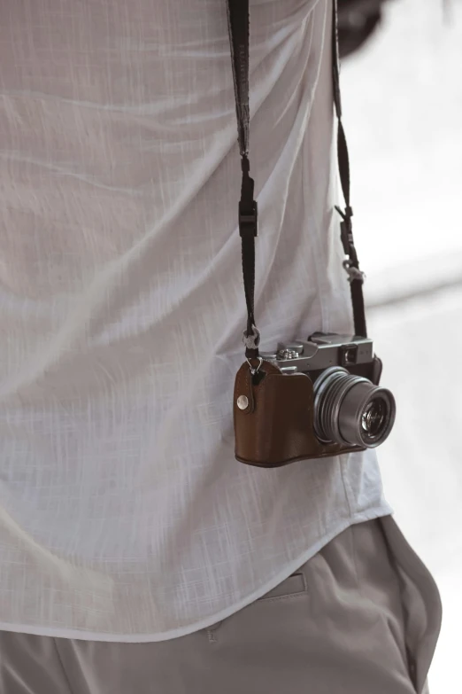 a camera strap is attached to a plain white background