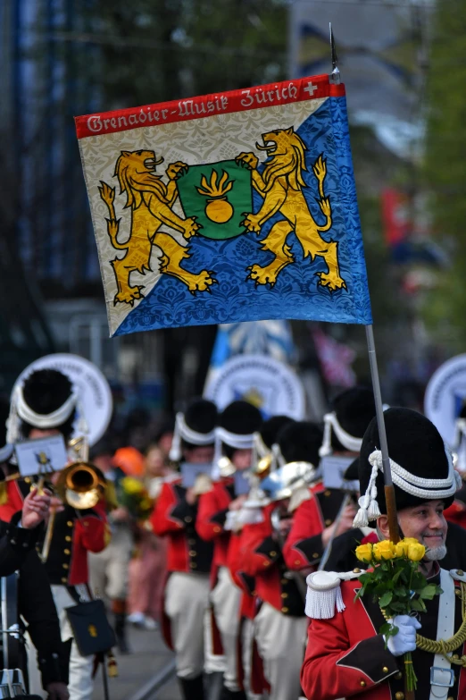 a marching band is holding a flag in a parade