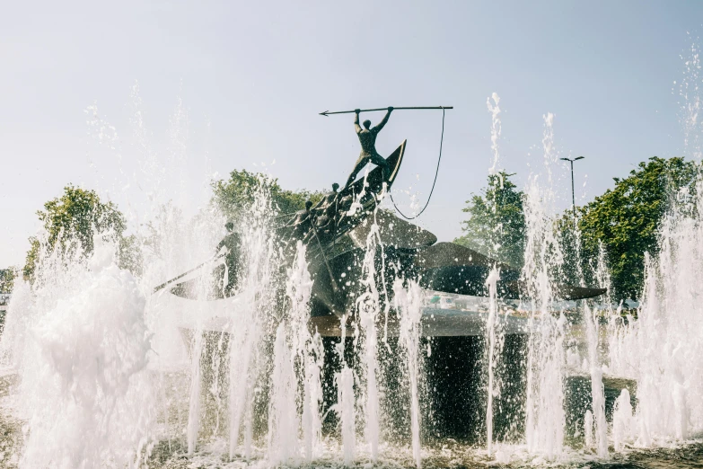 a man on horse statue spewing water in an open field