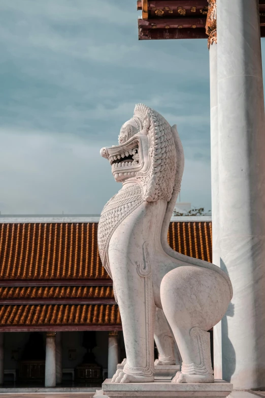 a white sculpture on top of a cement pedestal