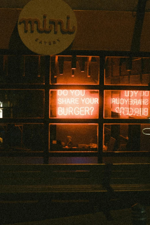 this neon sign has a message saying do you share your burger?