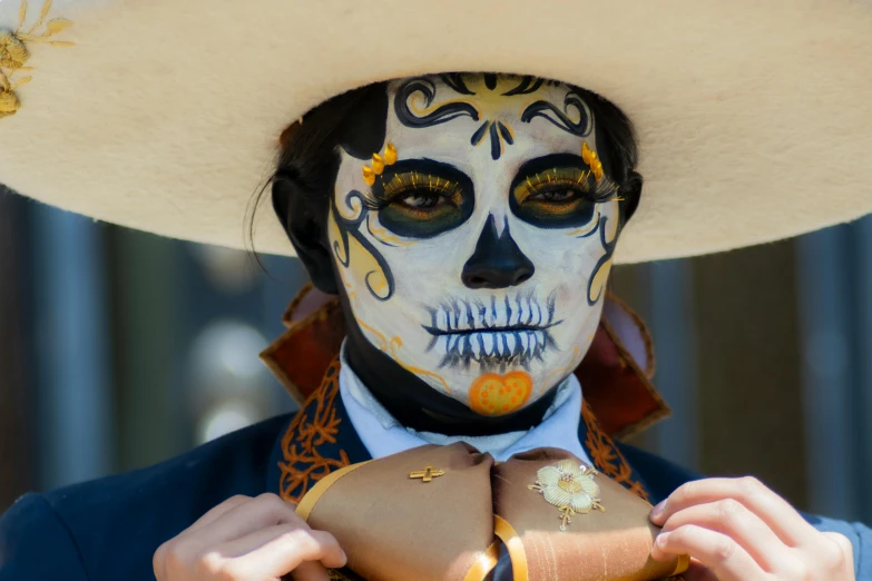 the mexican man in white mask is holding up a heart shaped piece