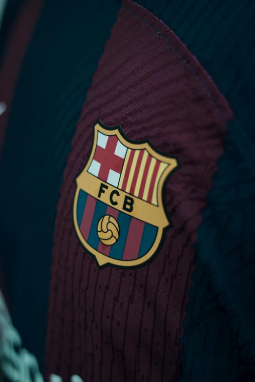 a soccer jersey with the logo of fc barcelona on it