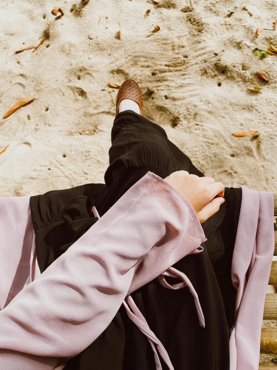 a person lying on the beach with a towel