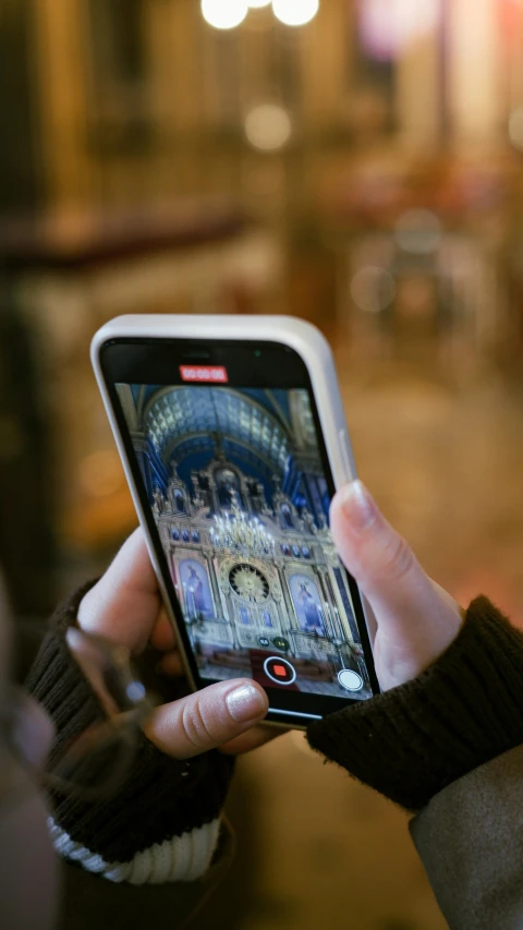 a close up of a person holding a cell phone in their hand