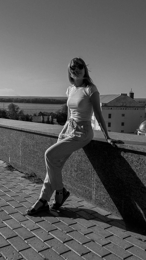 a woman leaning on a wall while posing for a po