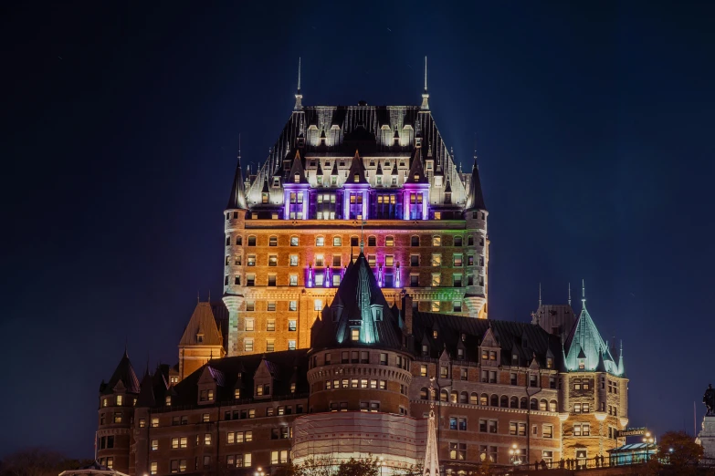 an elaborate building lit up in rainbow colors