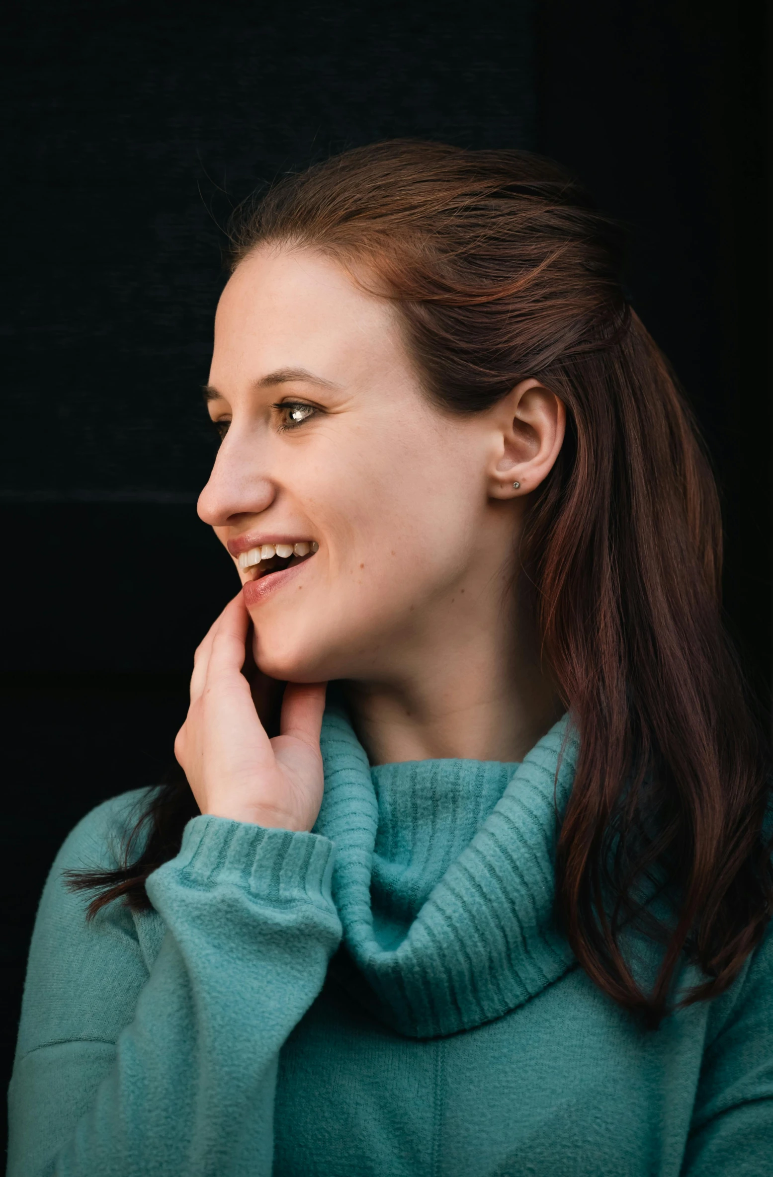 a woman smiles brightly as she poses for the camera