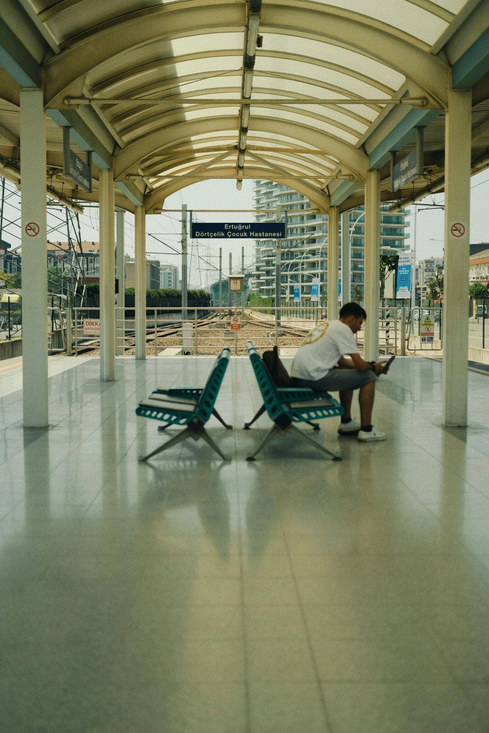 a man sitting in an underpass reading a book