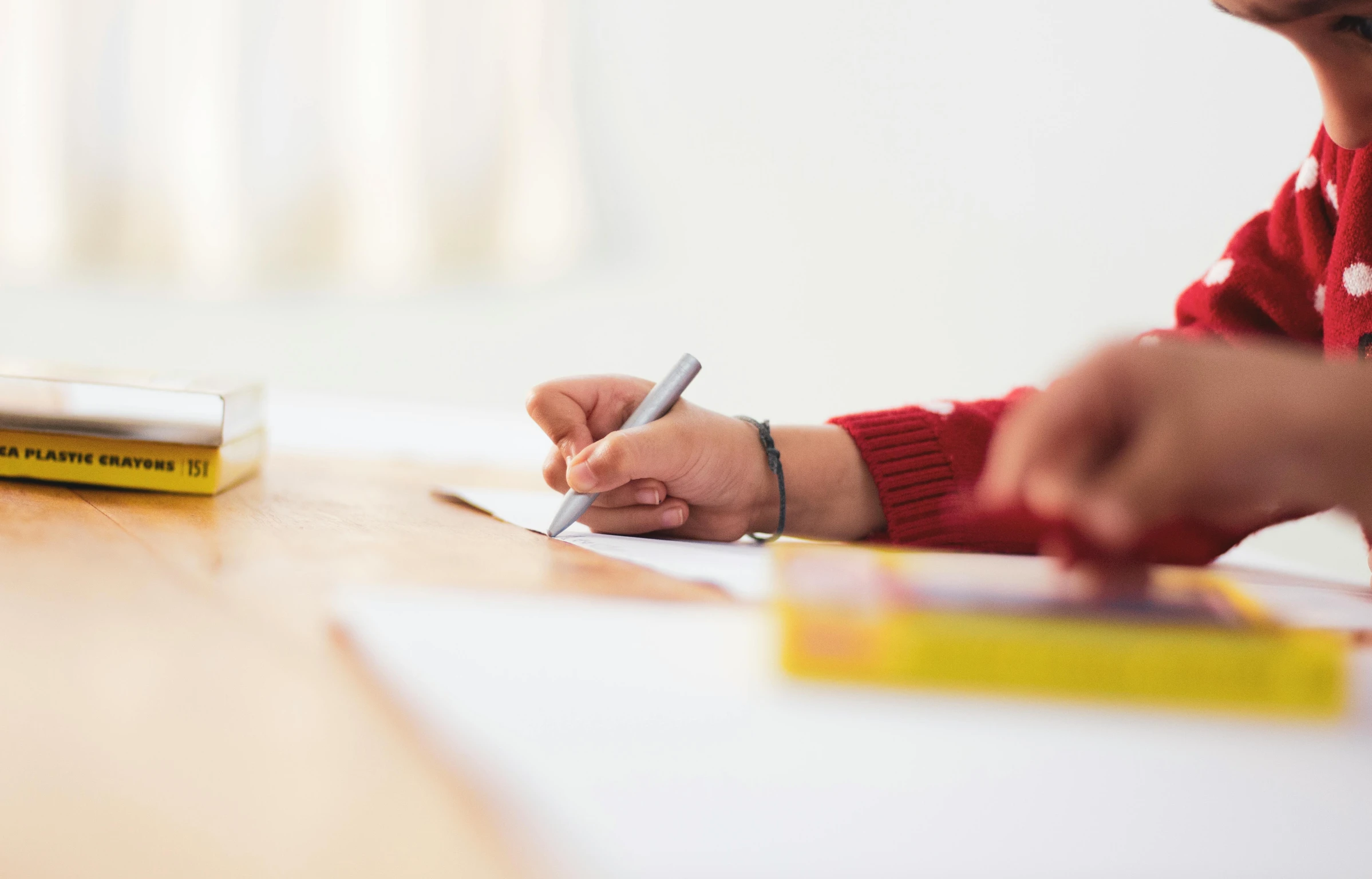 two people signing on paper next to each other