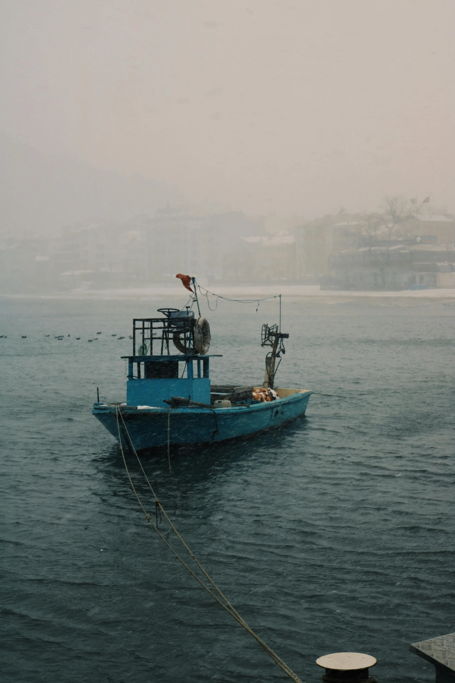 a blue boat floating on top of water