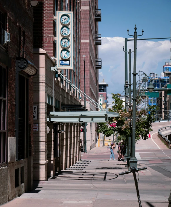 street light on pole next to city street with pedestrians