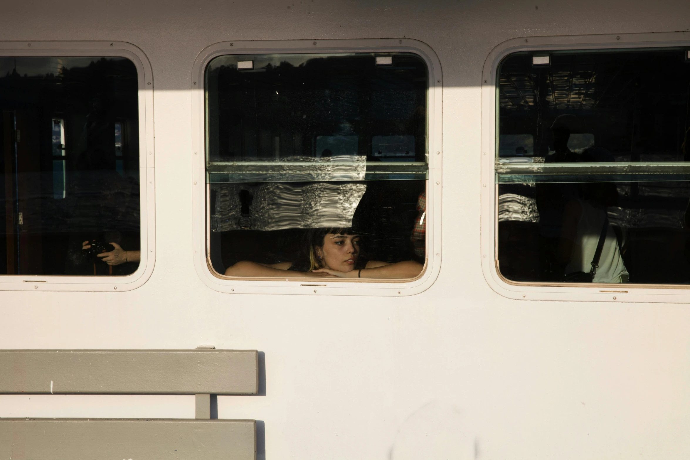 a woman is looking out of the window