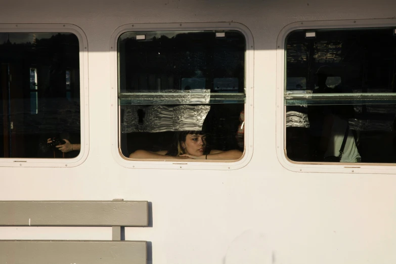 a woman is looking out of the window