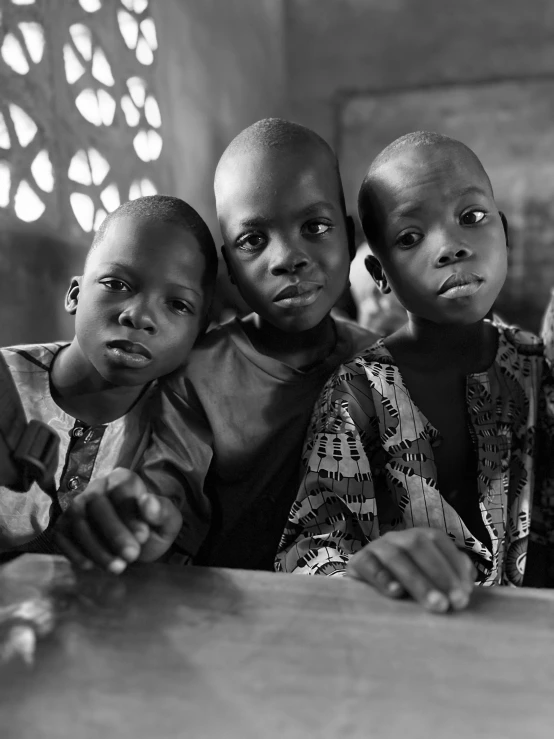 three children in a black and white po with a stain glass window