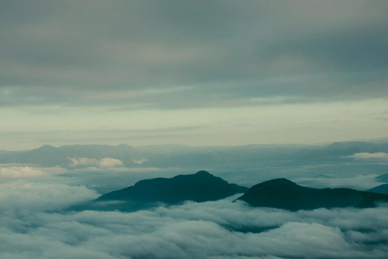 a plane flying above some clouds in the sky