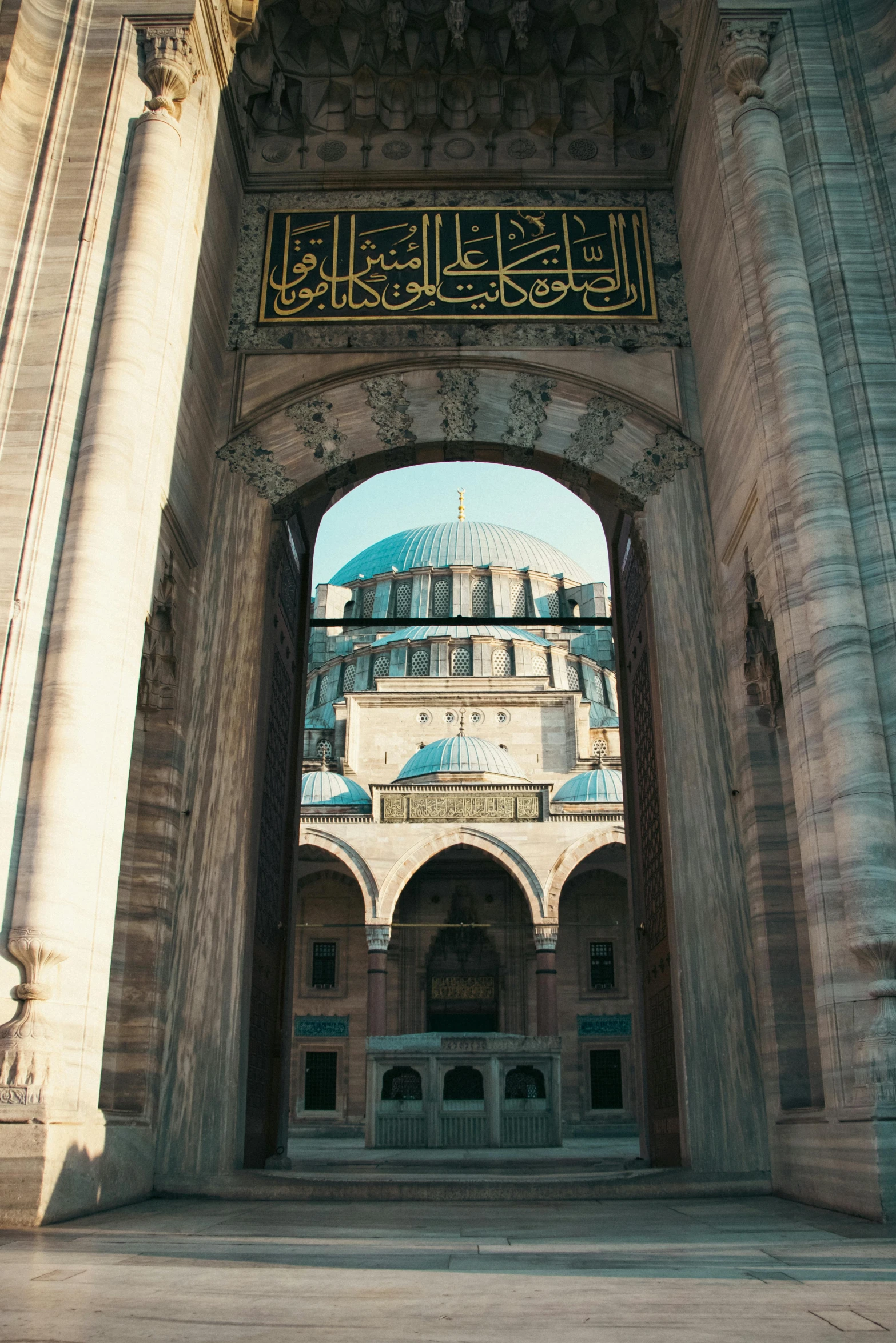 the entrance to an ornate building on a sunny day