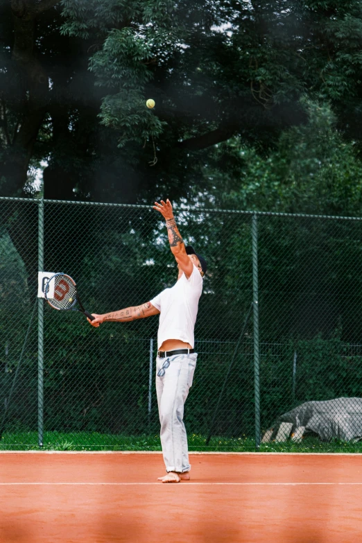 a man on a court with a tennis racket