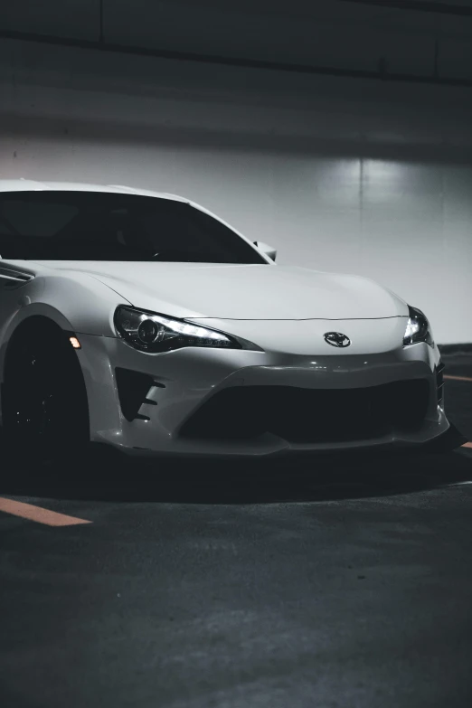 a sports car parked in a parking lot in the dark