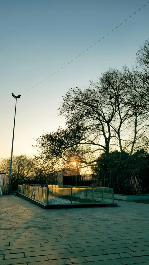 a light post sitting on top of a brick walkway