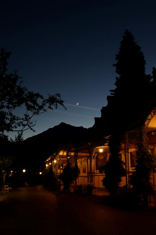 a home lit up in front of the night sky