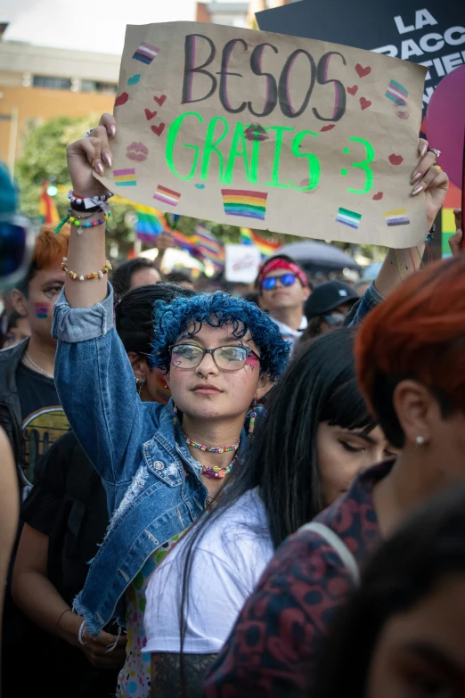 a crowd with lots of people holding signs and other protesting