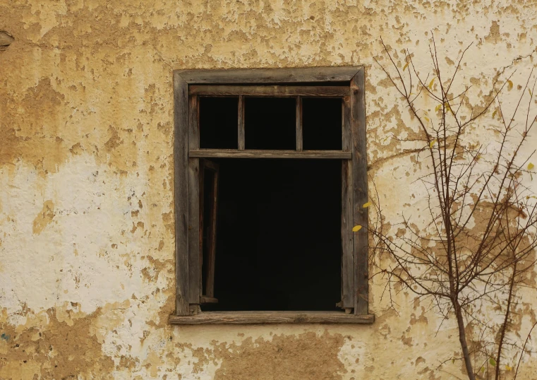 an old building has an open window with bars in it