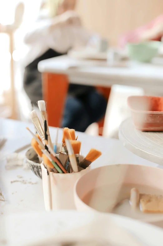 a white table with lots of pens and markers