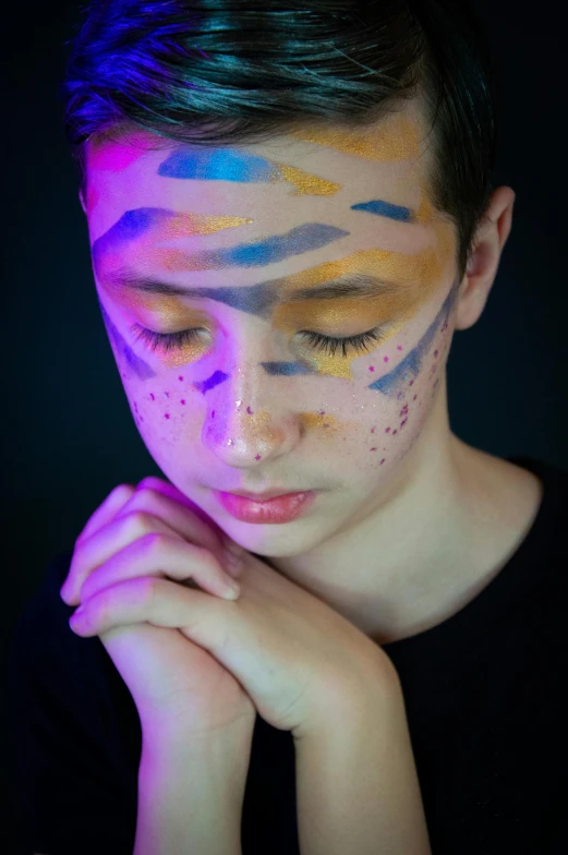 a girl has her face painted with colorful paint