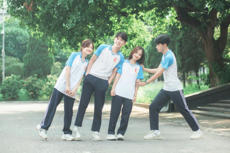 a group of people wearing blue and white shirts and jeans