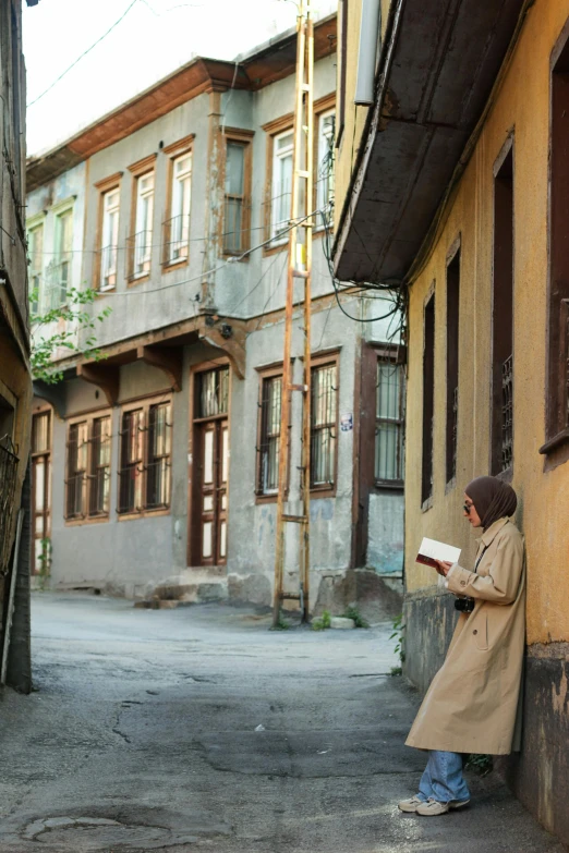 an elderly man reading in a large alley way