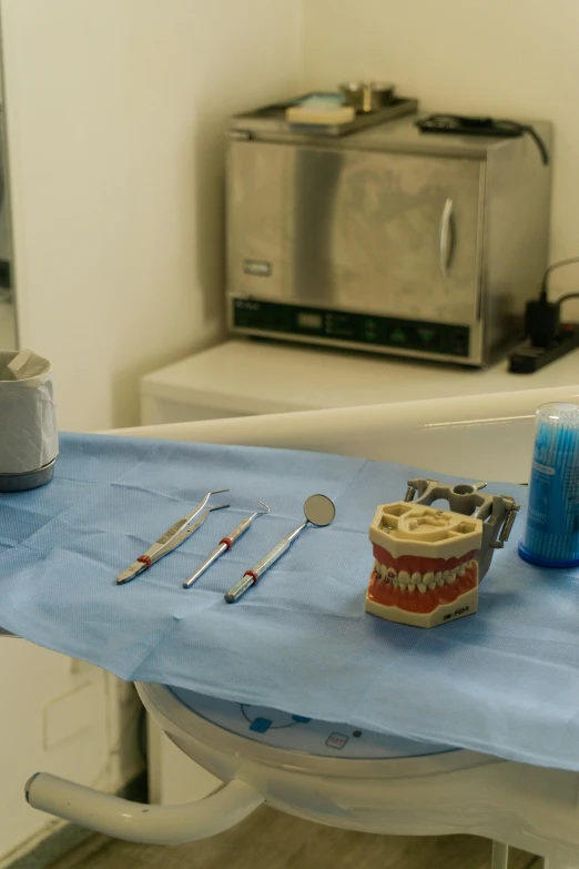 dental supplies on blue cloth on the edge of a table