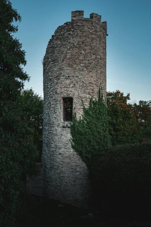 a tall brick tower with a clock on it's side