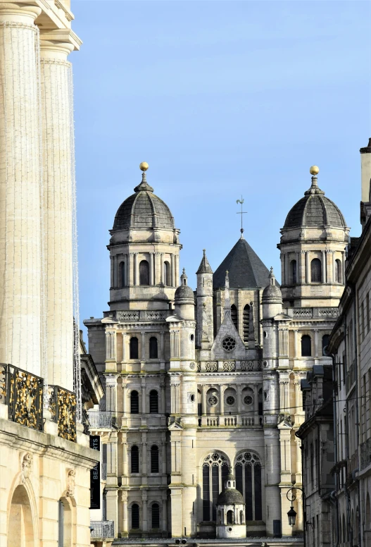 an architectural structure on a clear day with buildings in the background