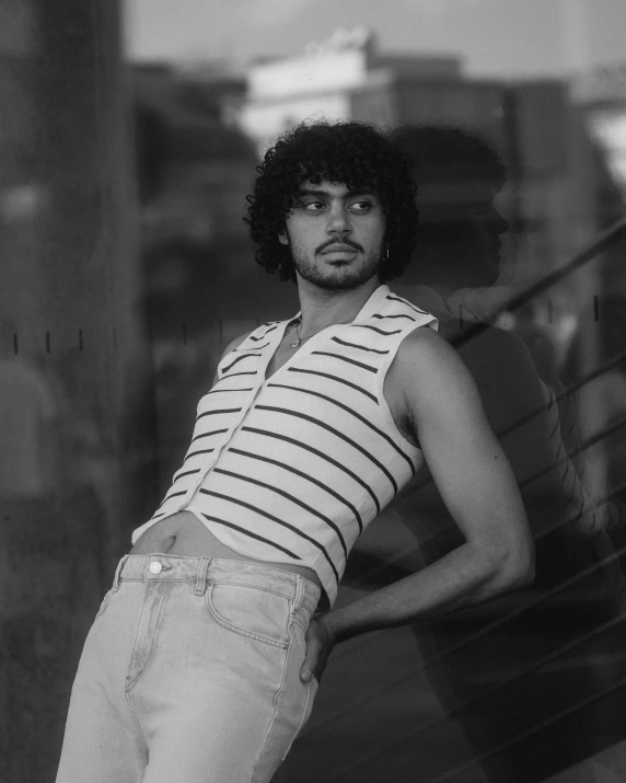 a young man leaning on stairs in a black and white po