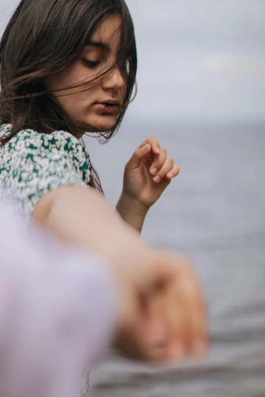 young woman holding onto soing in her hand with no other hand