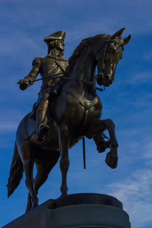 a statue of a man riding on the back of a horse