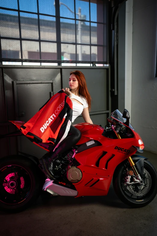 a woman sits atop her motorcycle in front of the door