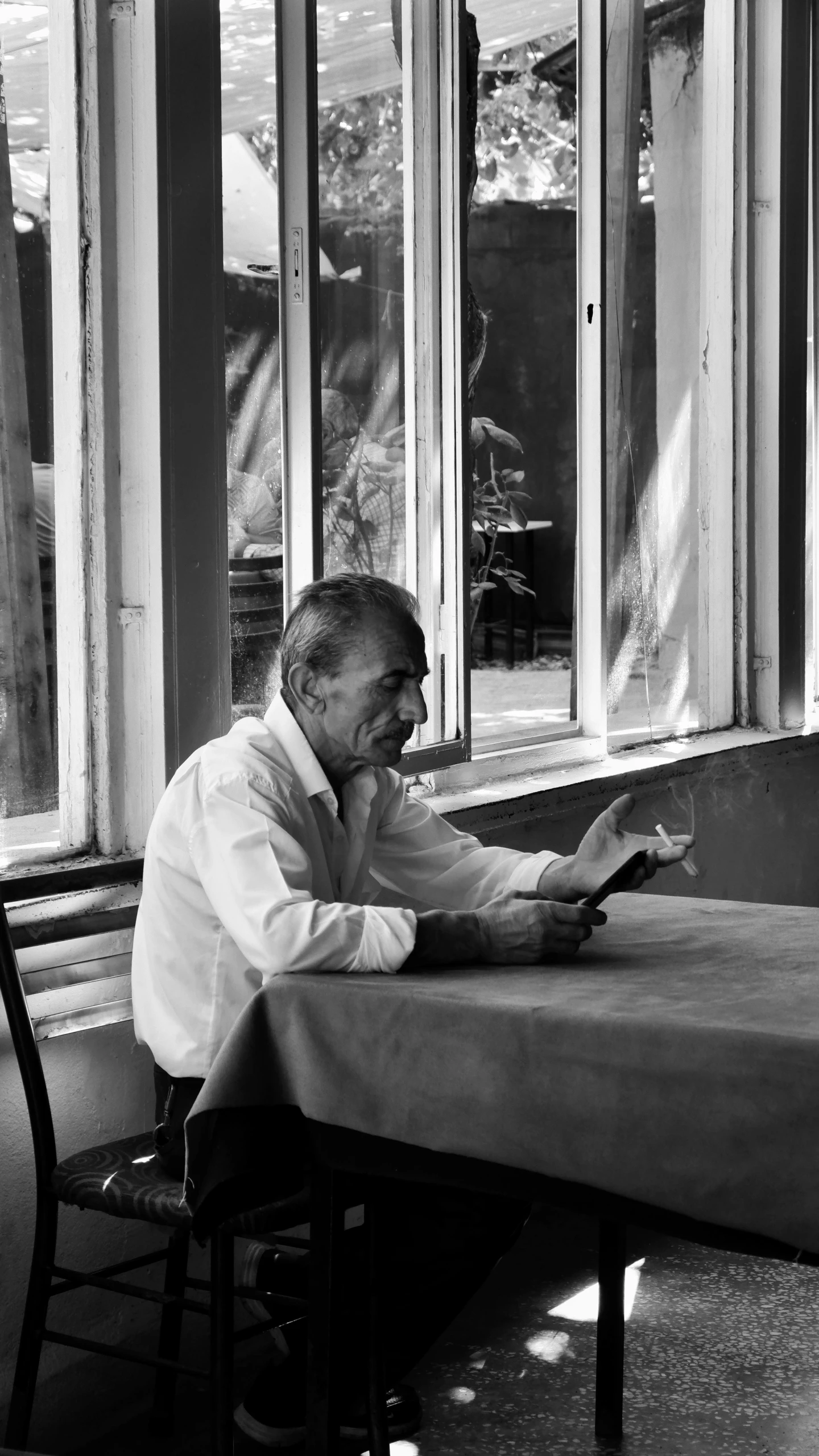 a man sitting at a table with a tablet